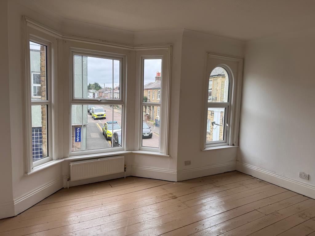 Lot: 80 - FREEHOLD TOWN CENTRE HOUSE COMMERCIAL INVESTMENT AND CAR PARK - Bedroom with wooden floor and white walls